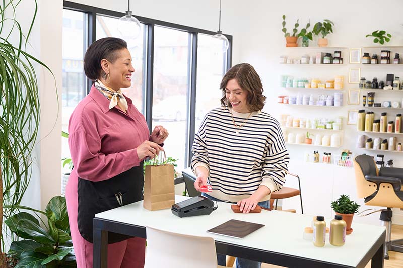Salon owner taking a credit card payment